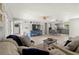 Bright open-concept living room, featuring hardwood floors, modern furniture, and seamless access to the kitchen area at 2016 Culberson Ave, Dunedin, FL 34698