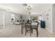 Open-concept living space showcasing the dining area, living room, and access to the outdoor space at 2016 Culberson Ave, Dunedin, FL 34698