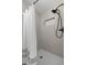 Updated shower with herringbone design, new showerhead, and tiled walls in remodeled bathroom at 2016 Culberson Ave, Dunedin, FL 34698