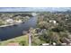 An aerial view shows a home along the river with a view of the city in the distance at 2102 W Ivy St, Tampa, FL 33607