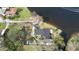 An aerial view shows a home with waterfront access and a dark roof at 2102 W Ivy St, Tampa, FL 33607