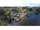 This aerial view shows a waterfront home with a large yard and easy water access at 2102 W Ivy St, Tampa, FL 33607