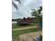 Lakefront property featuring a well-kept backyard with wood deck and outdoor seating area at 2102 W Ivy St, Tampa, FL 33607