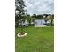 Lakeside backyard featuring picnic tables and palm trees, perfect for outdoor enjoyment at 2102 W Ivy St, Tampa, FL 33607