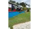 Outdoor entertaining space with ample seating around a brightly painted raised patio at 2102 W Ivy St, Tampa, FL 33607
