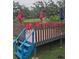 Charming outdoor dining area with a deck and colorful umbrellas for shade at 2102 W Ivy St, Tampa, FL 33607