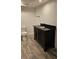 Bathroom featuring sleek black vanity with stone countertop and wood-look flooring at 2102 W Ivy St, Tampa, FL 33607