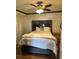 Comfortable bedroom featuring a large bed, ceiling fan and natural light at 2102 W Ivy St, Tampa, FL 33607