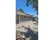 Gray building exterior with a walkway; colorful fence visible near the water at 2102 W Ivy St, Tampa, FL 33607