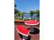 Inviting outdoor space with unique red picnic table and benches near a waterfront view at 2102 W Ivy St, Tampa, FL 33607