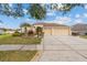 Beautiful one-story home with manicured lawn, palm trees, and a two-car garage at 22623 Cliffside Way, Land O Lakes, FL 34639