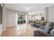 Bright living room showcasing tile floors, ceiling fan, and sliding glass doors to the outdoor area at 22623 Cliffside Way, Land O Lakes, FL 34639