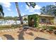 Spacious backyard with a custom stone fire pit area, perfect for outdoor entertaining at 2940 Bay View Dr, Safety Harbor, FL 34695