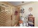 Bathroom featuring a checker-patterned shower behind glass and a toilet with a wooden seat at 2940 Bay View Dr, Safety Harbor, FL 34695