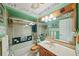 Green bathroom with white tiling and marble countertops at 2940 Bay View Dr, Safety Harbor, FL 34695