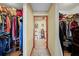 Bathroom access showing walk-in closets and a vanity with shelving for optimal storage at 2940 Bay View Dr, Safety Harbor, FL 34695