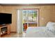 Cozy bedroom with sliding glass doors leading to the backyard and hot tub at 2940 Bay View Dr, Safety Harbor, FL 34695