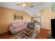 A cozy living room with hardwood floors, ceiling fan, and comfortable seating arrangement at 2940 Bay View Dr, Safety Harbor, FL 34695