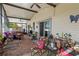 Enclosed patio featuring brick flooring and comfortable seating with a hot tub at 2940 Bay View Dr, Safety Harbor, FL 34695