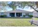 Backyard view of the home featuring a screened-in lanai at 31841 Larkenheath Dr, Wesley Chapel, FL 33543