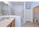 Bathroom with a sink, tiled shower, and adjacent toilet area for added privacy at 31841 Larkenheath Dr, Wesley Chapel, FL 33543