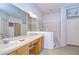 Bathroom with double sinks, tile flooring, and a separate shower and toilet area at 31841 Larkenheath Dr, Wesley Chapel, FL 33543