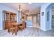 Charming dining area with a view to the kitchen featuring wood floors and plenty of natural light at 31841 Larkenheath Dr, Wesley Chapel, FL 33543
