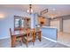 Dining area with a wooden table and chairs located near the kitchen and has views to the living room at 31841 Larkenheath Dr, Wesley Chapel, FL 33543