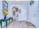 Inviting foyer with light blue walls, wood-look floors, and a decorative console table at 31841 Larkenheath Dr, Wesley Chapel, FL 33543