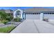 Charming single-story home with a three-car garage, manicured lawn, and lush landscaping at 31841 Larkenheath Dr, Wesley Chapel, FL 33543