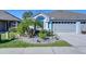 Charming single-story home with a three-car garage, manicured lawn, and lush landscaping at 31841 Larkenheath Dr, Wesley Chapel, FL 33543