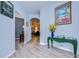 Hallway with wood floors, archways, and views of a living room, foyer and office space at 31841 Larkenheath Dr, Wesley Chapel, FL 33543
