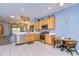 This kitchen features stainless steel appliances, wood cabinets, and a cozy dining area at 31841 Larkenheath Dr, Wesley Chapel, FL 33543