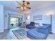 Comfortable living room featuring a plush sofa, stylish rug, and access to the screened patio at 31841 Larkenheath Dr, Wesley Chapel, FL 33543
