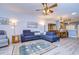 Open-concept layout with cozy living room, elegant furnishings, and views into dining area at 31841 Larkenheath Dr, Wesley Chapel, FL 33543