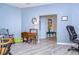 Light-filled living room with neutral walls, wood-look floors and vintage furniture at 31841 Larkenheath Dr, Wesley Chapel, FL 33543