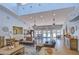 Spacious living room with high ceilings, tile floors, comfortable seating, and lots of natural light at 31841 Larkenheath Dr, Wesley Chapel, FL 33543