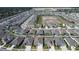Aerial view of the property in a neighborhood showing the roof, landscaping, and nearby homes at 3624 Autumn Amber Dr, Spring Hill, FL 34609