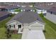 Aerial view of a single-Gathering home in a residential area, with a well-maintained lawn and two-car garage at 3624 Autumn Amber Dr, Spring Hill, FL 34609