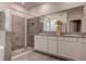 This bathroom features double sinks, granite countertops, and a spacious walk-in shower for convenience at 3624 Autumn Amber Dr, Spring Hill, FL 34609
