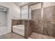 A modern bathroom features a soaking tub, glass-enclosed shower, and tile surround at 3624 Autumn Amber Dr, Spring Hill, FL 34609