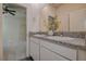 A bathroom features a double sink vanity with granite countertops, and ample cabinet space at 3624 Autumn Amber Dr, Spring Hill, FL 34609