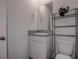 A well-lit bathroom features a modern vanity, a sink with granite countertop, and a convenient storage shelf at 3624 Autumn Amber Dr, Spring Hill, FL 34609