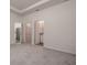 Spacious bedroom featuring carpet floors with closet and bathroom access at 3624 Autumn Amber Dr, Spring Hill, FL 34609