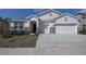 Front exterior with a well-manicured lawn and a two-car garage, enhancing the curb appeal at 3624 Autumn Amber Dr, Spring Hill, FL 34609