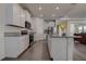 Modern kitchen with white cabinets, granite countertops, and stainless steel appliances at 3624 Autumn Amber Dr, Spring Hill, FL 34609