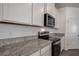 Kitchen countertop featuring granite, stainless steel appliances, and modern design elements at 3624 Autumn Amber Dr, Spring Hill, FL 34609