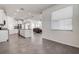 Open kitchen with stainless steel appliances, white cabinets and granite countertops adjoins a large living area at 3624 Autumn Amber Dr, Spring Hill, FL 34609