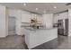 Modern kitchen features white cabinets, granite countertops, and stainless steel appliances at 3624 Autumn Amber Dr, Spring Hill, FL 34609