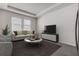 A cozy living room is furnished with a sofa, chairs, and a modern entertainment center for relaxation and entertainment at 3624 Autumn Amber Dr, Spring Hill, FL 34609